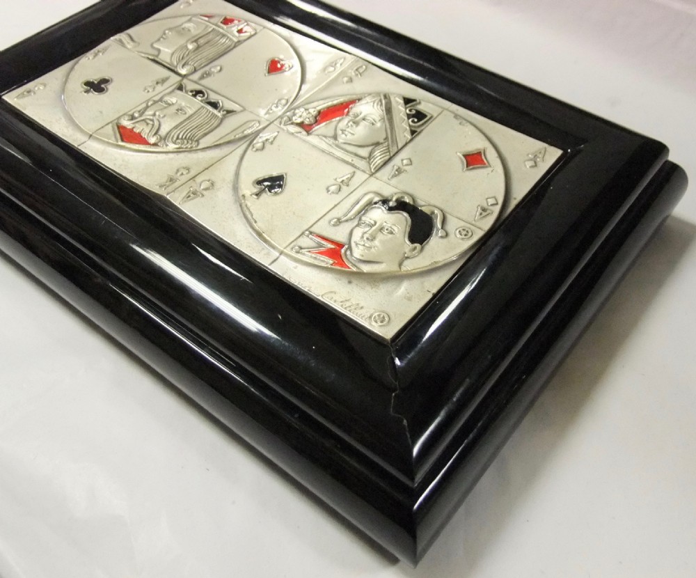 A rectangular black lacquer box featuring an inset silver and enamel lid panel depicting playing card faces and suit motifs. View IV