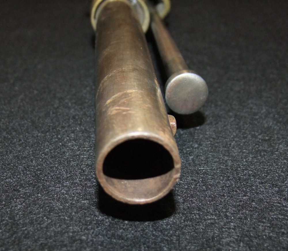 A mid-19th-century French percussion carbine featuring a dark walnut stock, brass fittings, a steel barrel, and an attached socket bayonet against a black background. View XIII