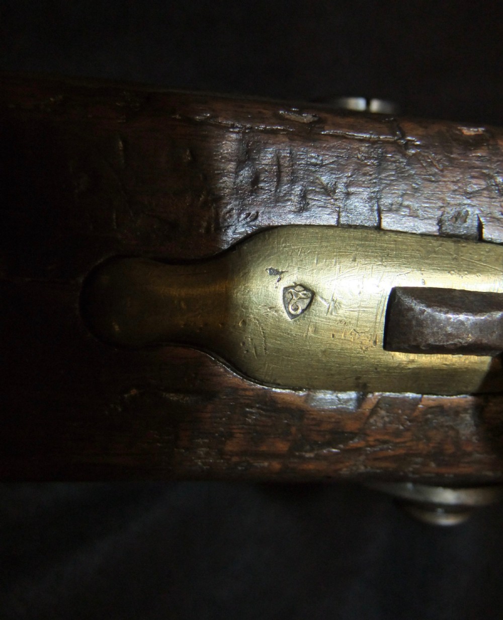 A mid-19th-century French percussion carbine featuring a dark walnut stock, brass fittings, a steel barrel, and an attached socket bayonet against a black background. View XVIII