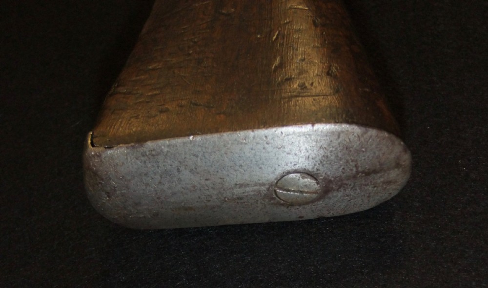 A mid-19th-century French percussion carbine featuring a dark walnut stock, brass fittings, a steel barrel, and an attached socket bayonet against a black background. View XIX