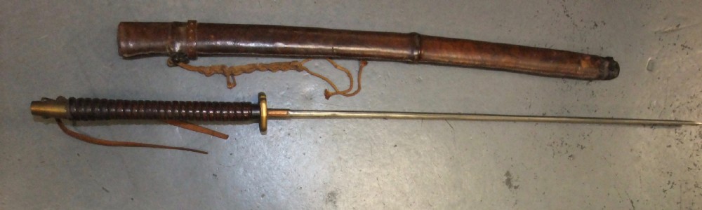 A Japanese WWII officers Shin-Gunto katana featuring a leather-wrapped scabbard, ribbed handle, and brass tsuba. View III