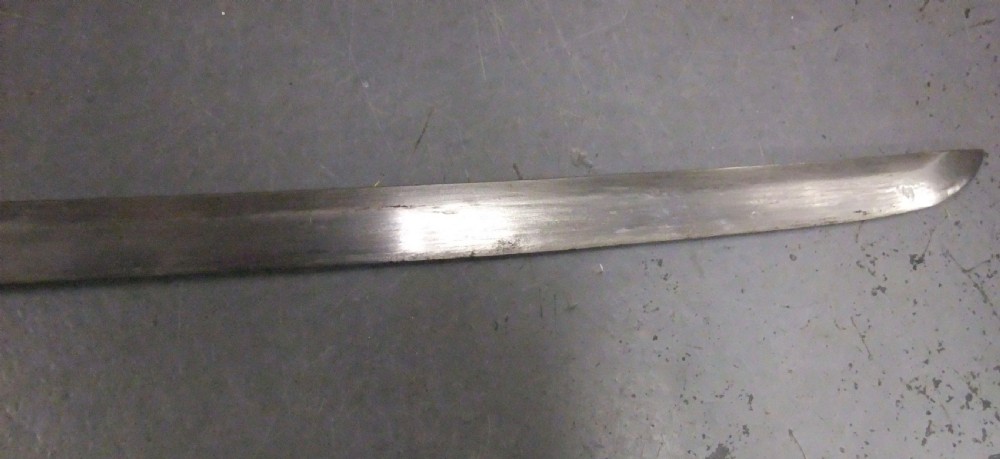 A Japanese WWII officers Shin-Gunto katana featuring a leather-wrapped scabbard, ribbed handle, and brass tsuba. View XI