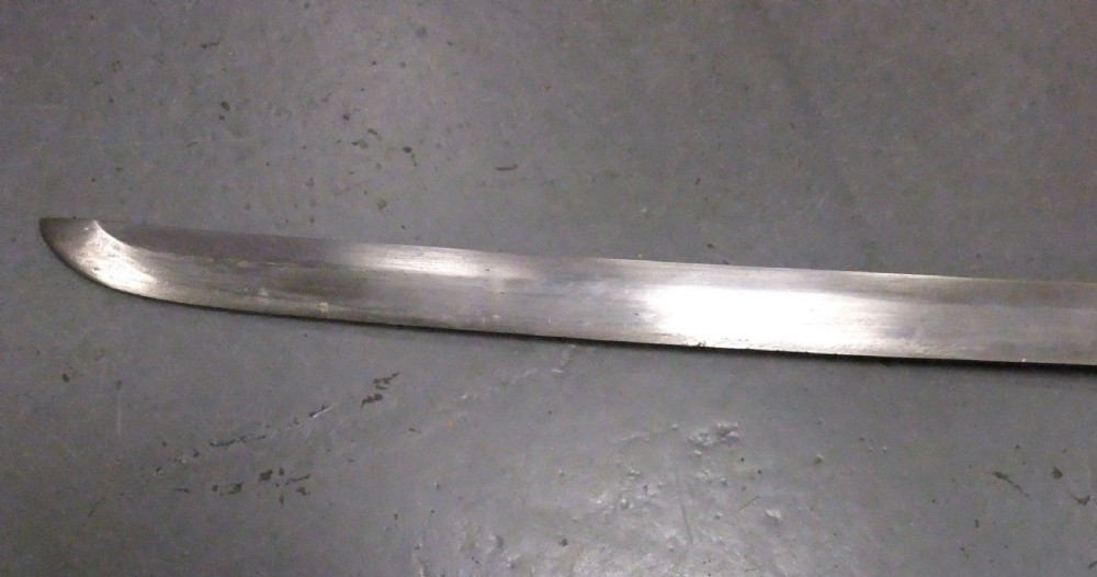 A Japanese WWII officers Shin-Gunto katana featuring a leather-wrapped scabbard, ribbed handle, and brass tsuba. View XIV