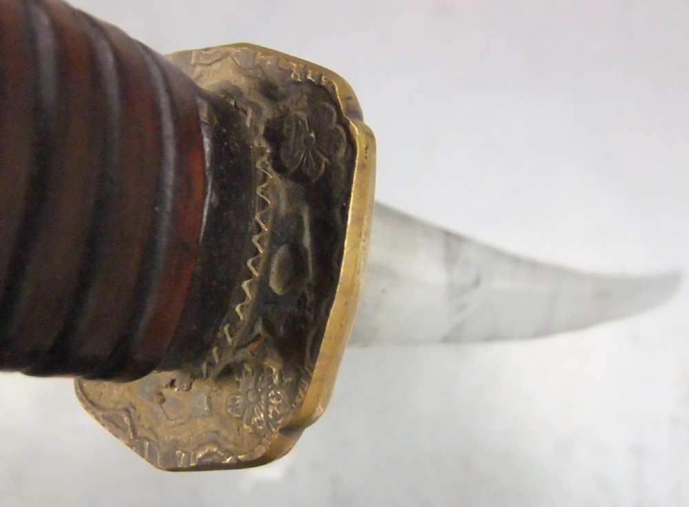 A Japanese WWII officers Shin-Gunto katana featuring a leather-wrapped scabbard, ribbed handle, and brass tsuba. View XVIII