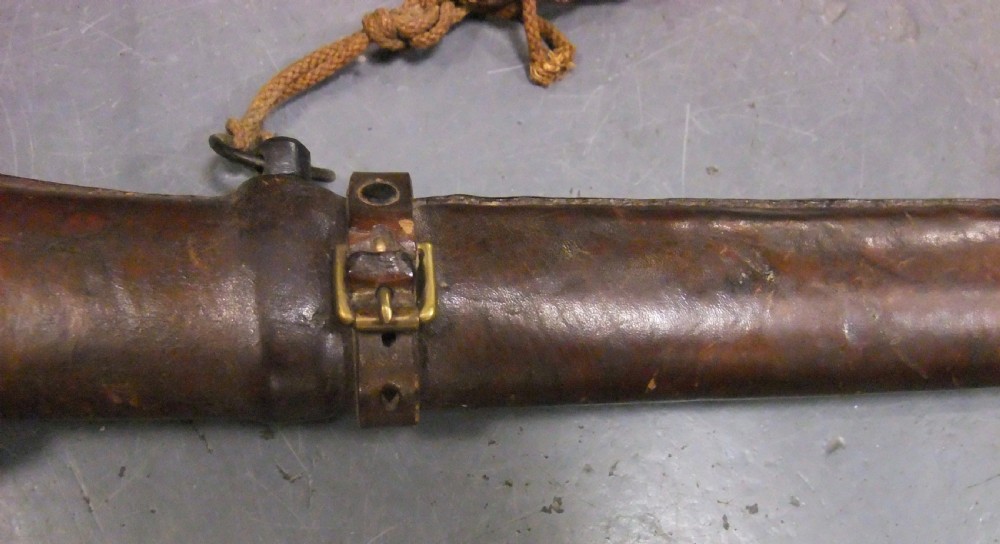 A Japanese WWII officers Shin-Gunto katana featuring a leather-wrapped scabbard, ribbed handle, and brass tsuba. View XXII