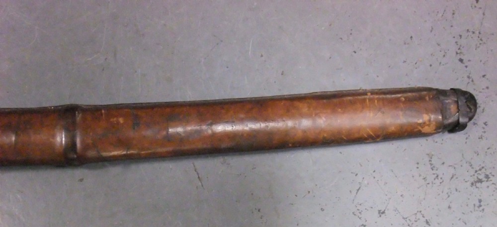 A Japanese WWII officers Shin-Gunto katana featuring a leather-wrapped scabbard, ribbed handle, and brass tsuba. View XXIII