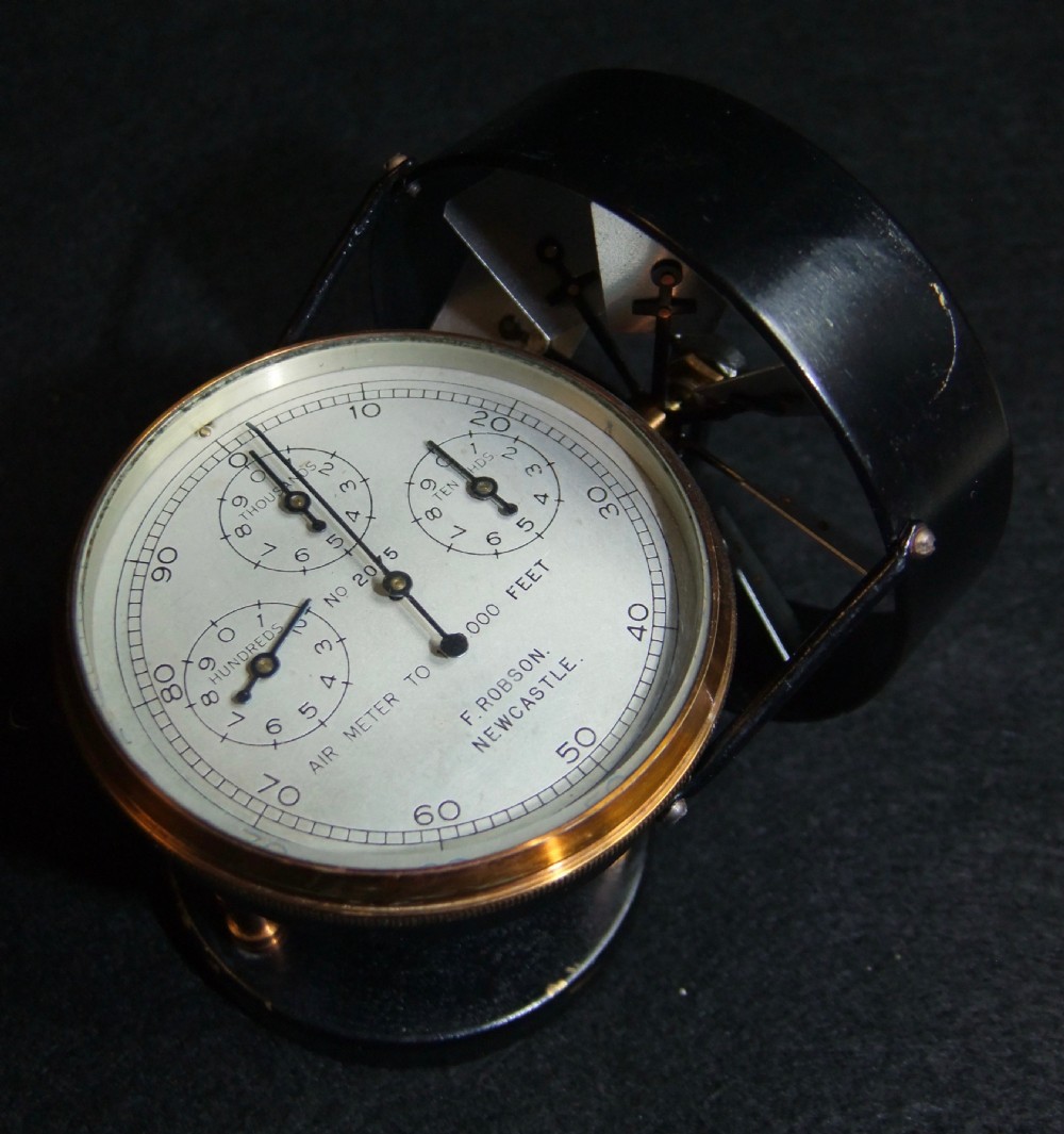A nineteenth-century brass and black metal high-speed anemometer with multiple sub-dials, mounted on a wooden box. View VII