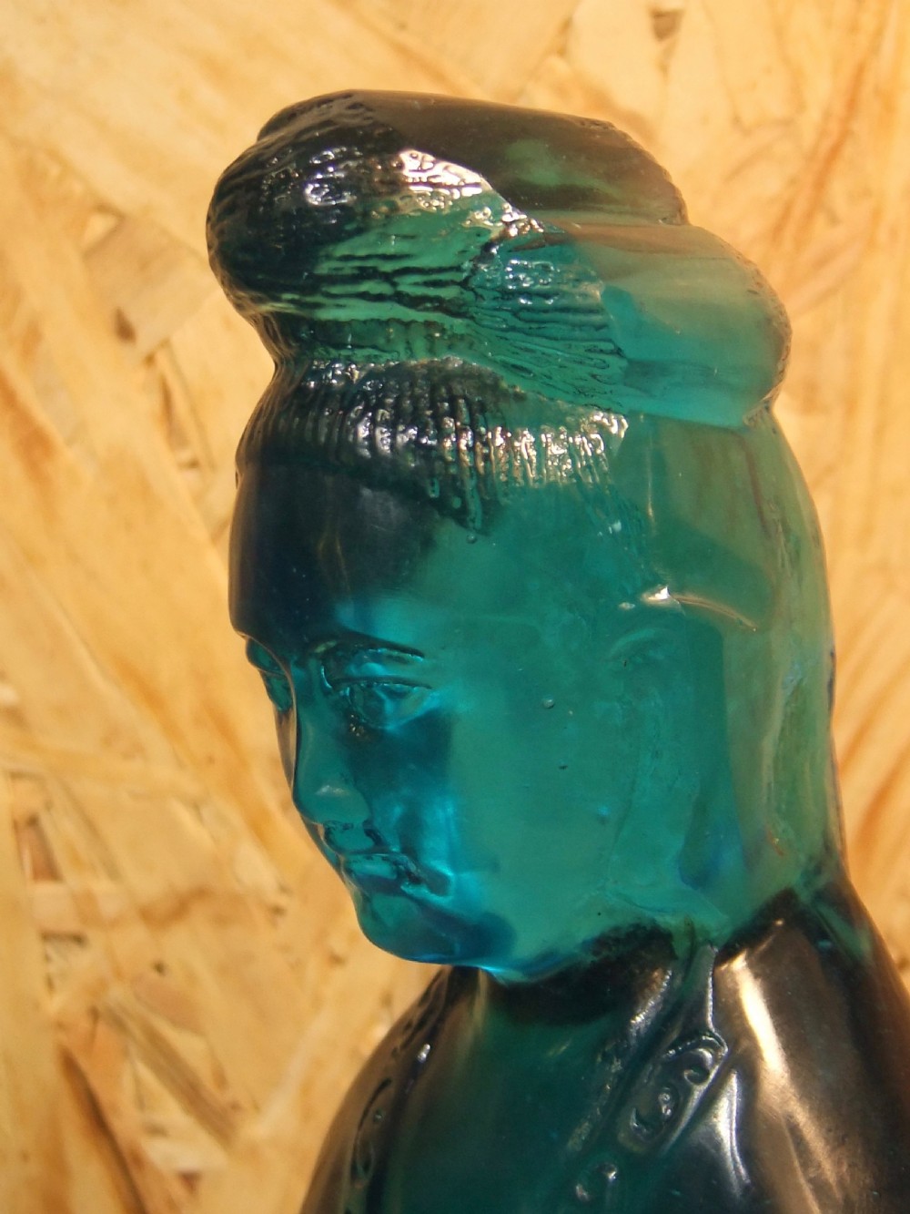 A 19th-century turquoise blue translucent Peking glass figurine depicting the Bodhisattva Guanyin standing in traditional robes. View VI