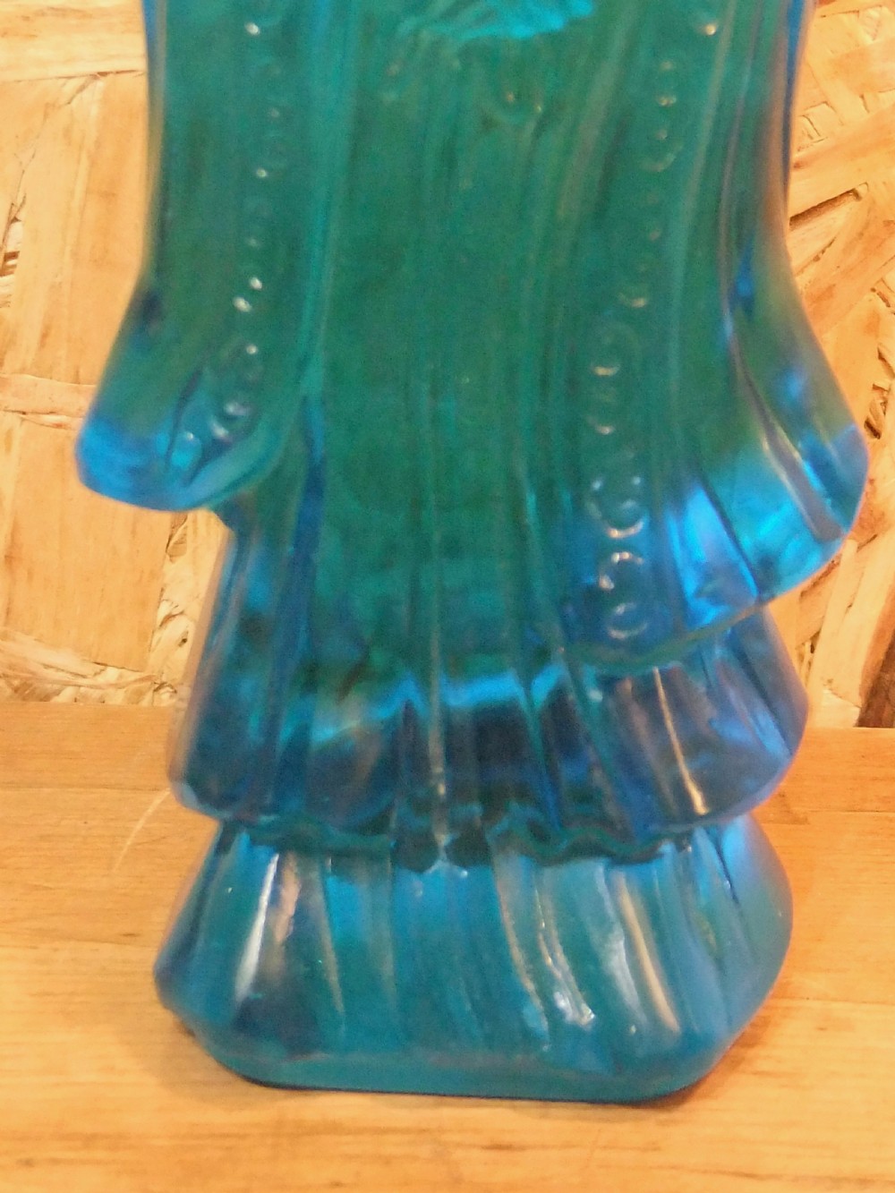 A 19th-century turquoise blue translucent Peking glass figurine depicting the Bodhisattva Guanyin standing in traditional robes. View IX
