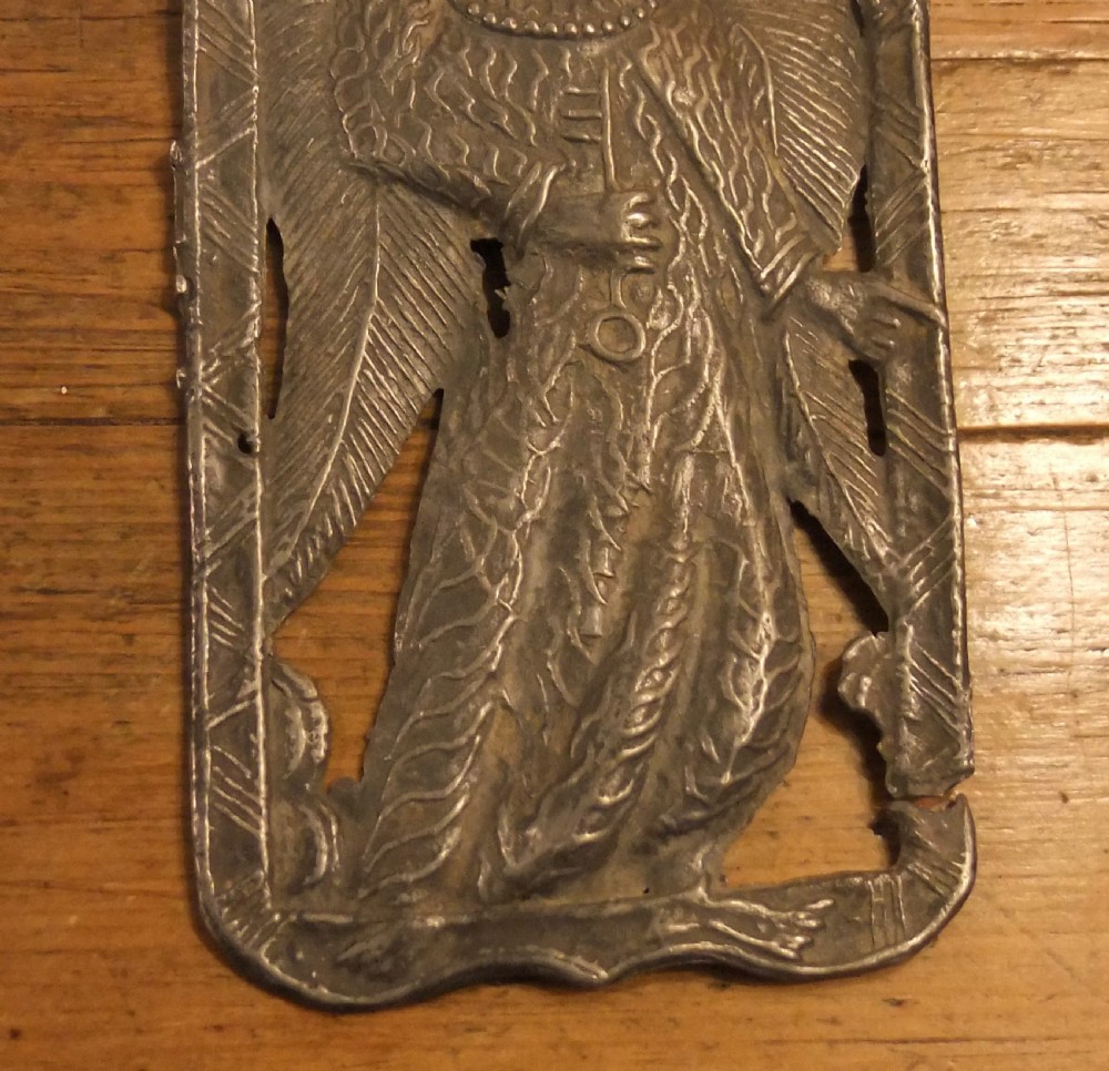 A grey lead alloy hinged diptych panel featuring a crude relief casting of a haloed figure holding a key alongside a companion panel with pseudo-medieval inscriptions. View VIII