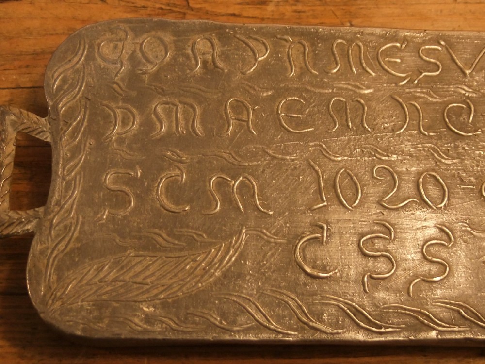 A grey lead alloy hinged diptych panel featuring a crude relief casting of a haloed figure holding a key alongside a companion panel with pseudo-medieval inscriptions. View XIV