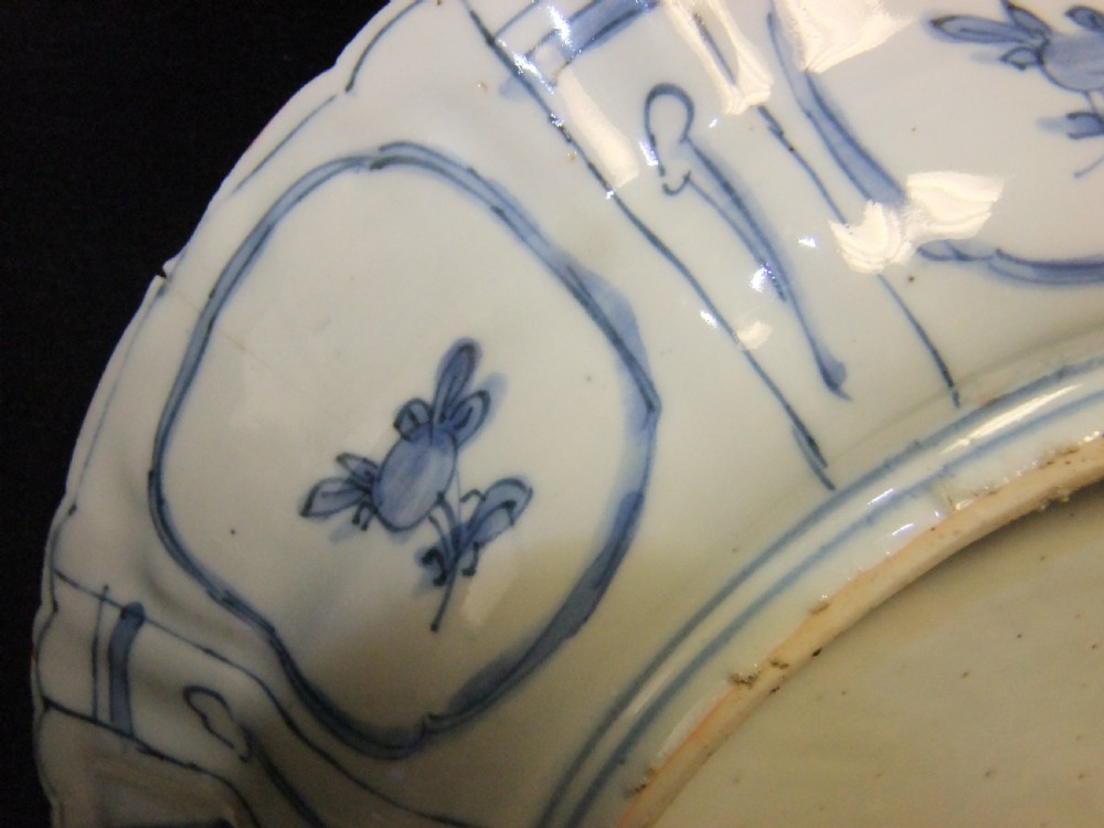 A Chinese Wanli Kraak porcelain deep plate decorated in underglaze blue with central birds and plants surrounded by a panelled rim with a scalloped edge. View VIII