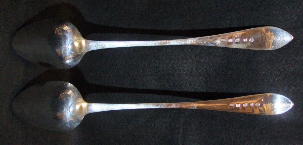 A pair of polished sterling silver George III Scottish basting spoons featuring pointed handles with subtle engraved monograms. View III