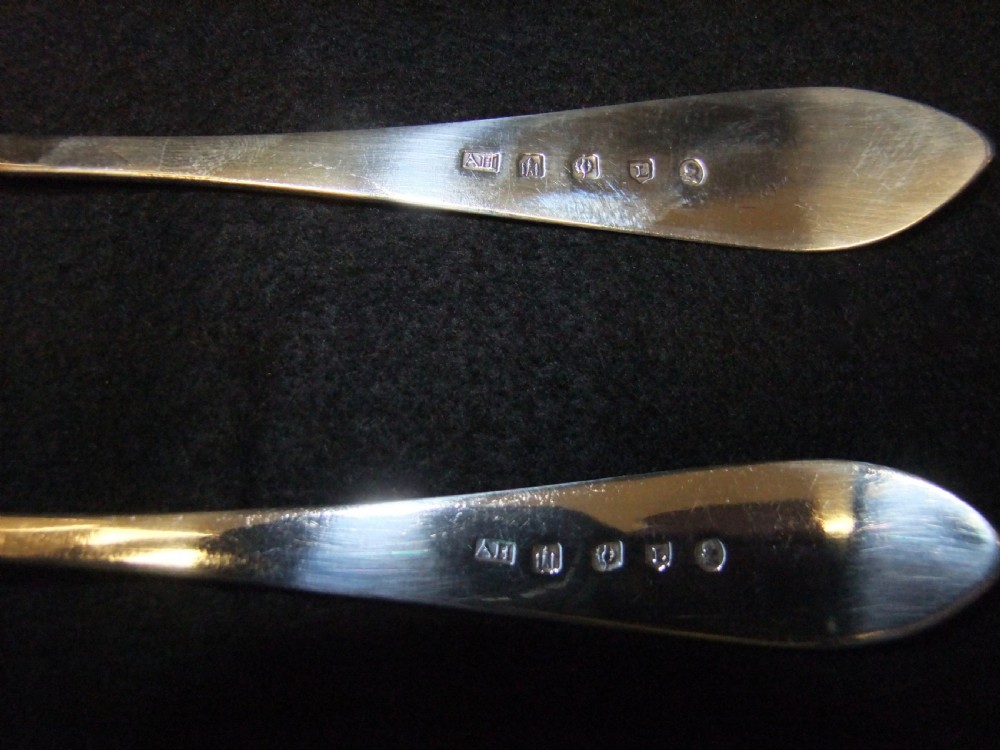 A pair of polished sterling silver George III Scottish basting spoons featuring pointed handles with subtle engraved monograms. View IV