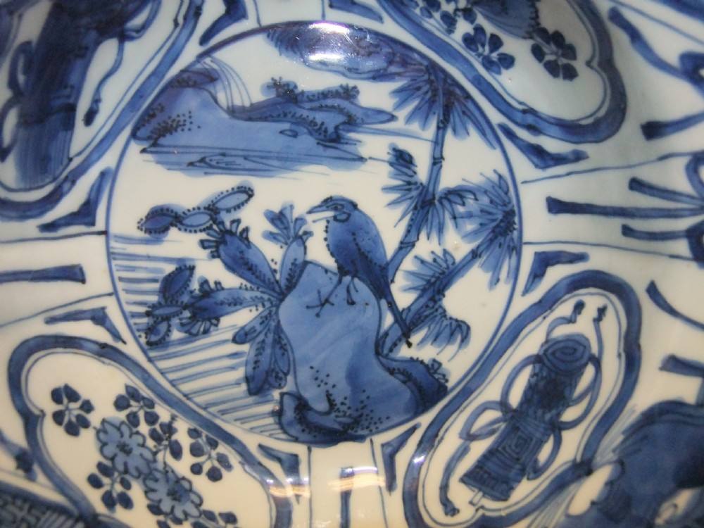A circular Wanli period Kraak porcelain klapmuts bowl decorated with cobalt blue underglaze landscapes and panelled rim motifs. View II