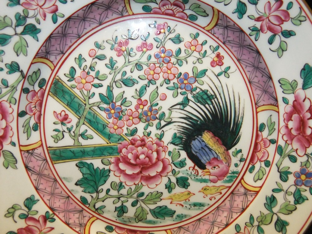 A pair of circular Chinese export porcelain plates decorated with hand-painted roosters, peonies, and pink and green floral borders. View III