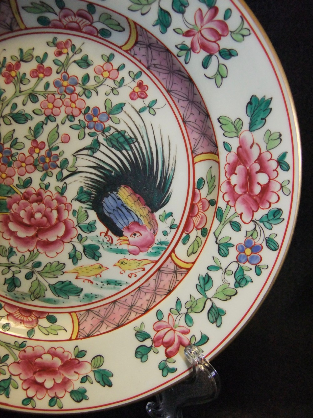 A pair of circular Chinese export porcelain plates decorated with hand-painted roosters, peonies, and pink and green floral borders. View V