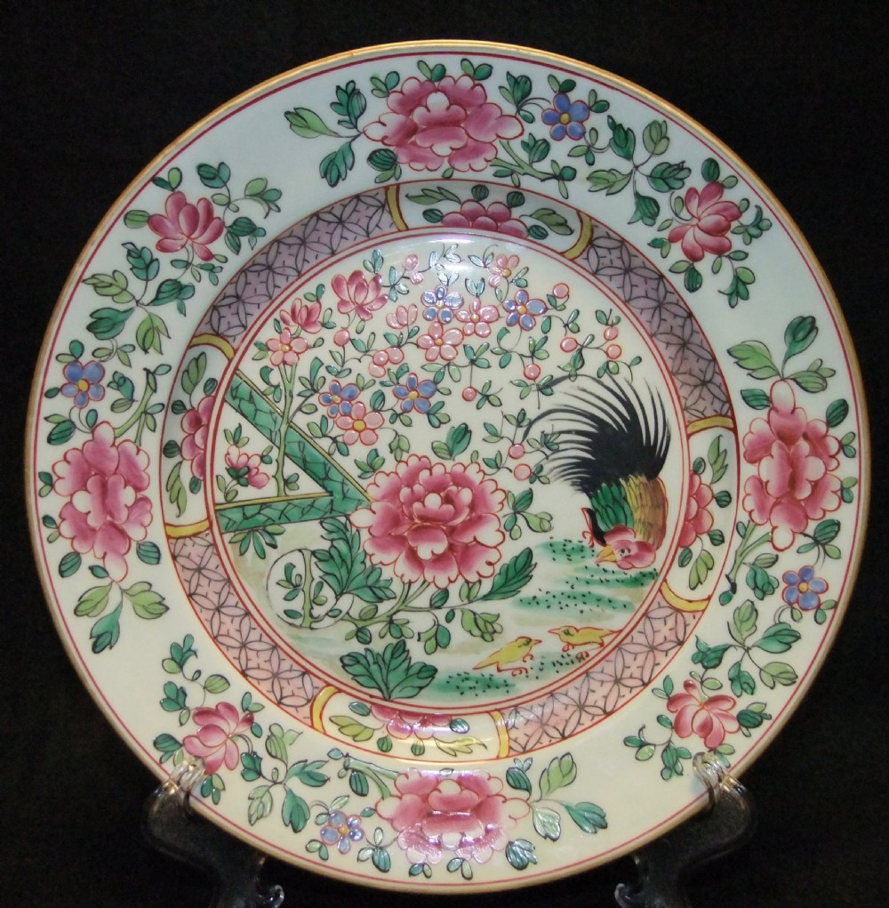 A pair of circular Chinese export porcelain plates decorated with hand-painted roosters, peonies, and pink and green floral borders. View IX