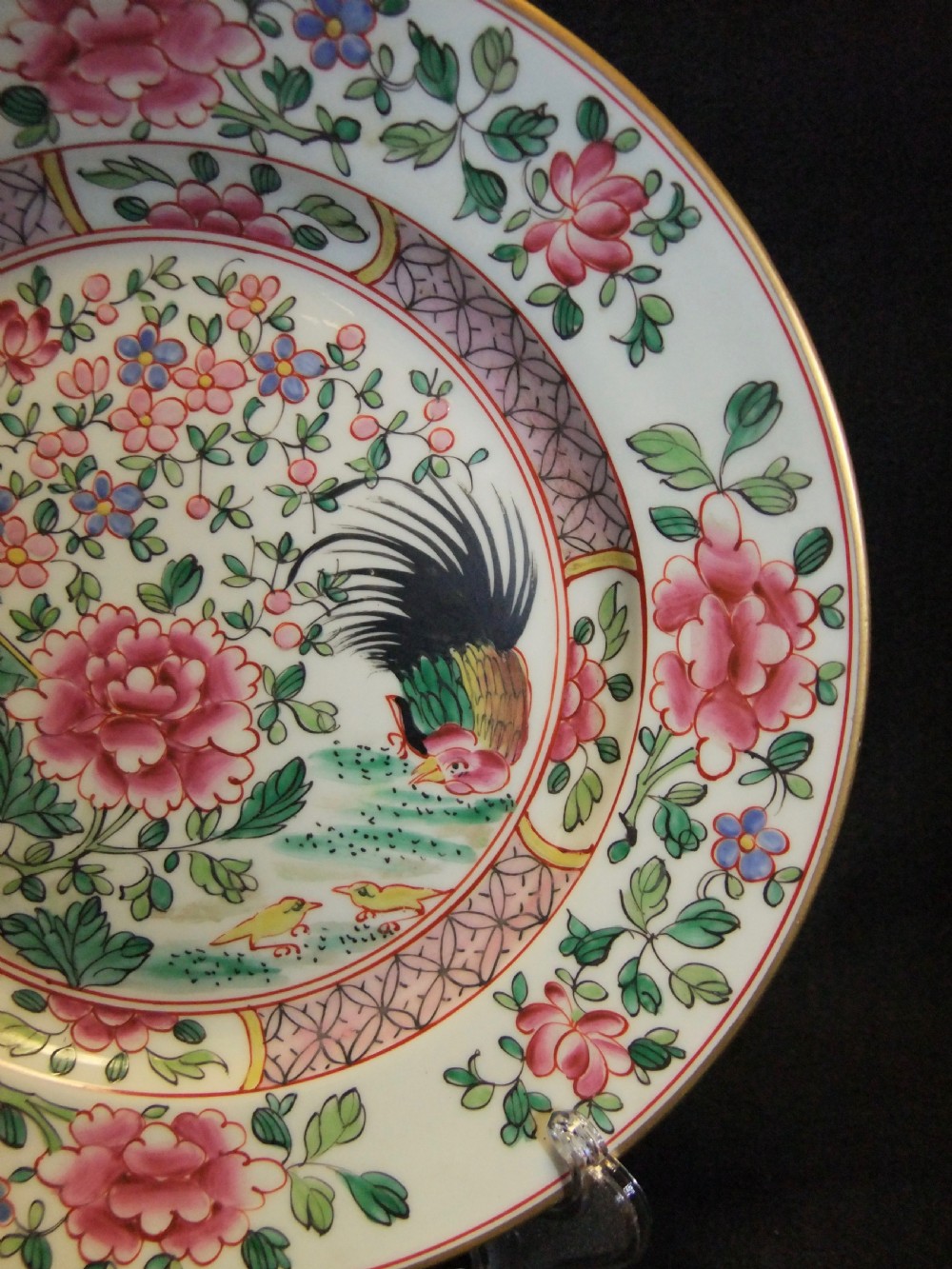 A pair of circular Chinese export porcelain plates decorated with hand-painted roosters, peonies, and pink and green floral borders. View XII