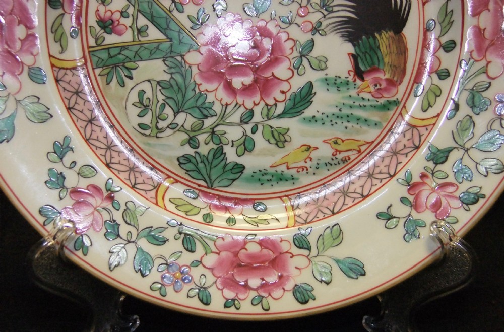 A pair of circular Chinese export porcelain plates decorated with hand-painted roosters, peonies, and pink and green floral borders. View XIII