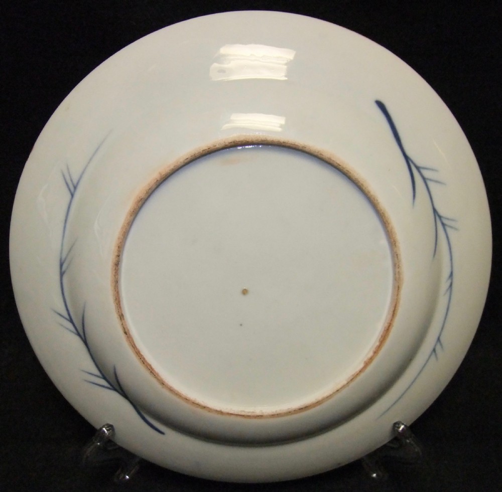 A pair of circular Japanese Edo Period Imari porcelain plates featuring intricate floral motifs in underglaze blue, iron red, and gold gilding on a white ground. View XV