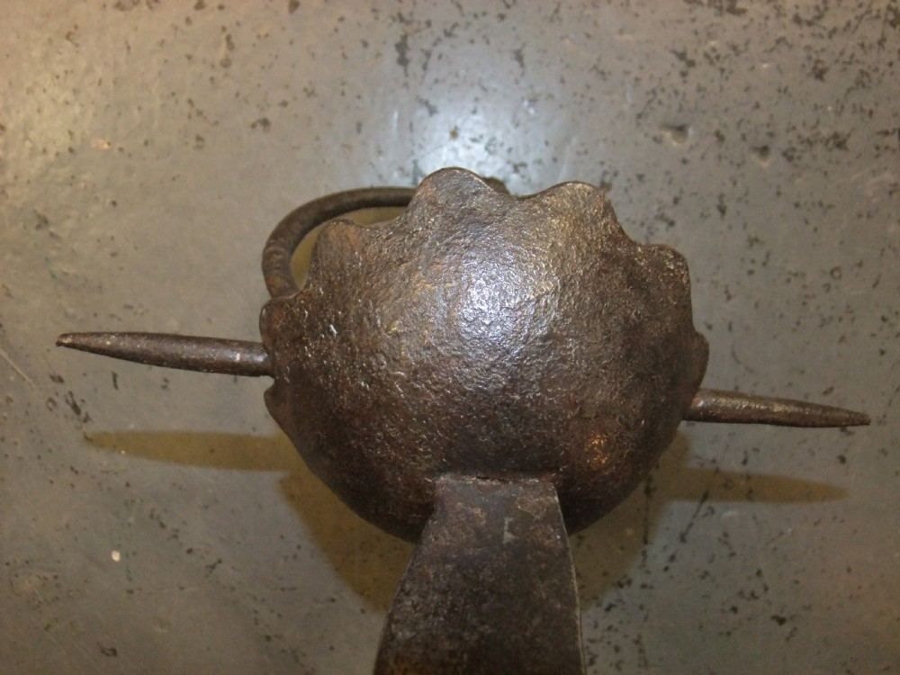 A 17th-century steel cup-hilt sword featuring a long wavy flamberge blade and a rounded metal hand guard. View X