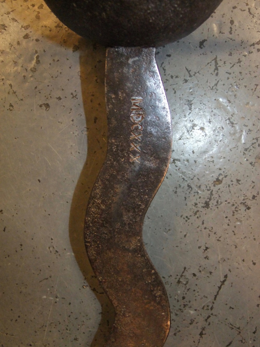 A 17th-century steel cup-hilt sword featuring a long wavy flamberge blade and a rounded metal hand guard. View XII