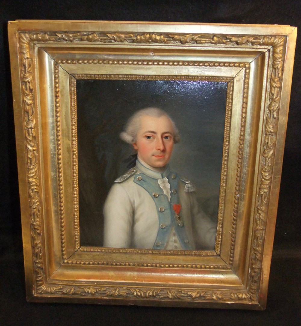 An 18th-century oil portrait depicting a male military officer in a white and blue uniform inside a molded gold gilded frame.