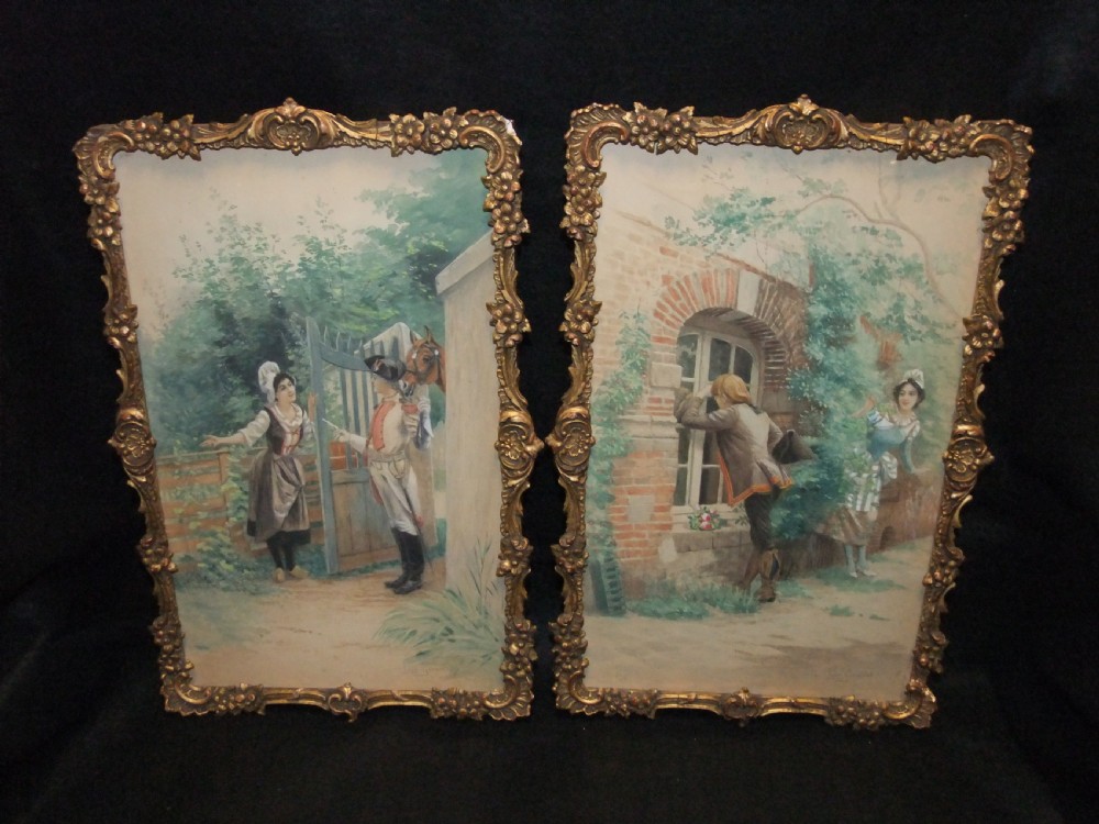 A pair of nineteenth-century watercolour paintings depicting figures in historic attire outside brick buildings, framed in ornate gilt floral frames.
