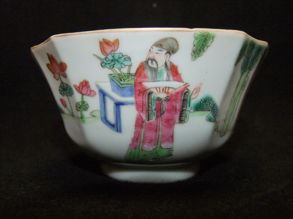 An octagonal Chinese white porcelain bowl decorated with hand-painted famille rose enamels featuring a figure in pink robes and lotus blossoms. View III