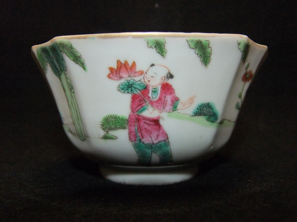 An octagonal Chinese white porcelain bowl decorated with hand-painted famille rose enamels featuring a figure in pink robes and lotus blossoms. View IV