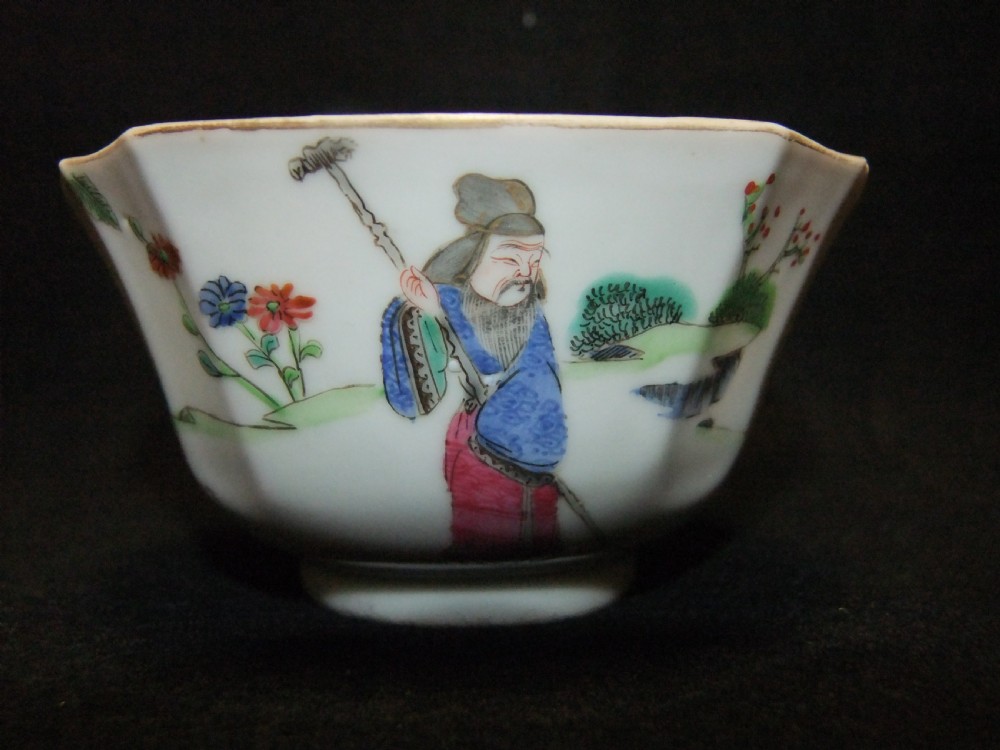 An octagonal Chinese white porcelain bowl decorated with hand-painted famille rose enamels featuring a figure in pink robes and lotus blossoms. View V