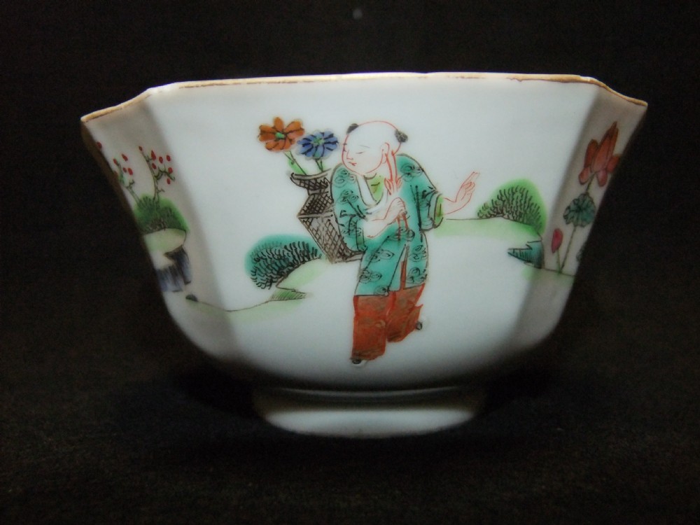 An octagonal Chinese white porcelain bowl decorated with hand-painted famille rose enamels featuring a figure in pink robes and lotus blossoms. View VI