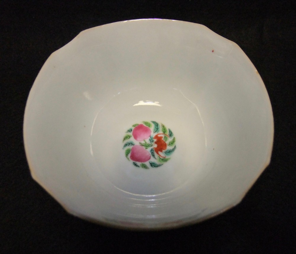 An octagonal Chinese white porcelain bowl decorated with hand-painted famille rose enamels featuring a figure in pink robes and lotus blossoms. View VII