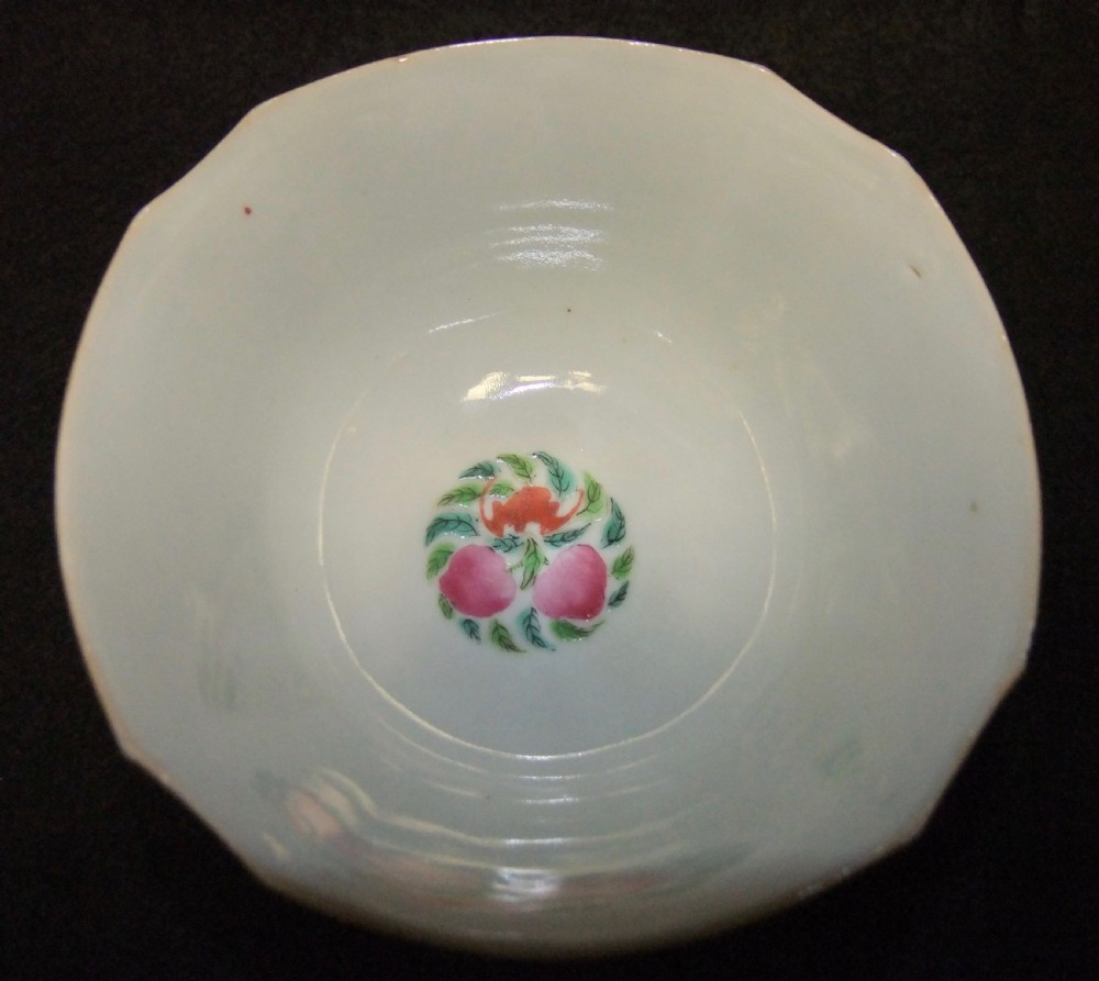 An octagonal Chinese white porcelain bowl decorated with hand-painted famille rose enamels featuring a figure in pink robes and lotus blossoms. View VIII