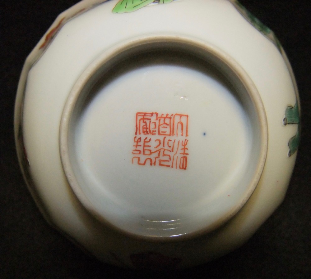 An octagonal Chinese white porcelain bowl decorated with hand-painted famille rose enamels featuring a figure in pink robes and lotus blossoms. View X