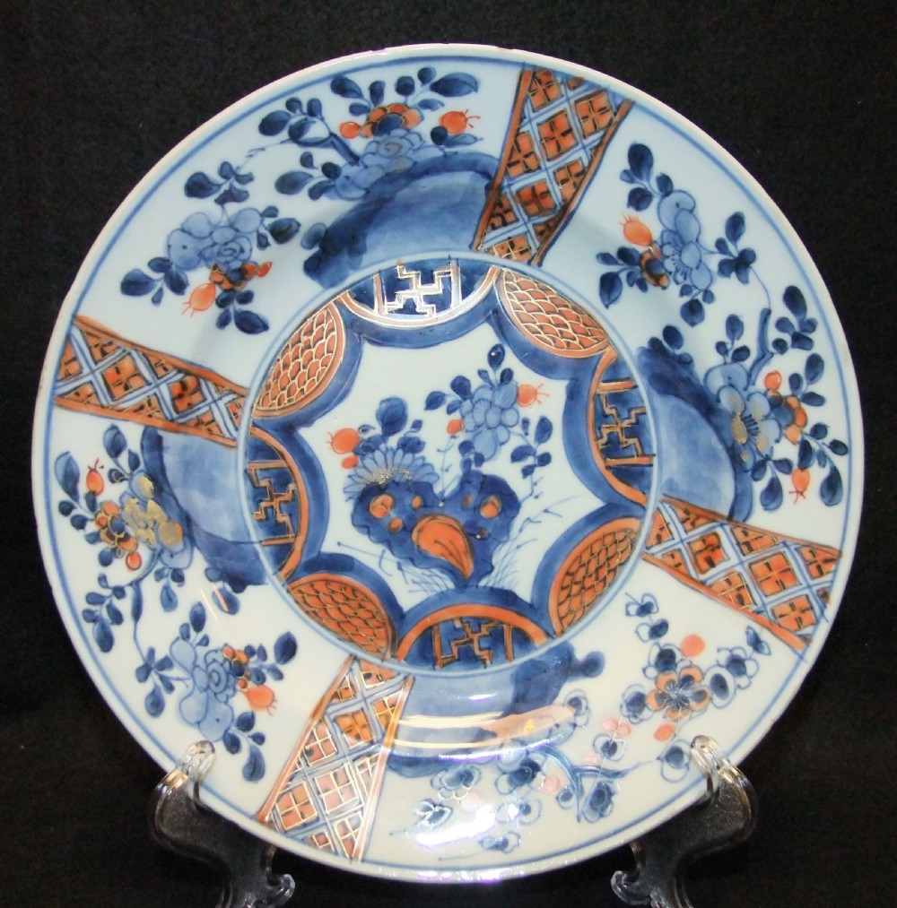 A set of six Chinese Imari porcelain plates featuring cobalt blue, iron red, and gilded floral motifs. View II