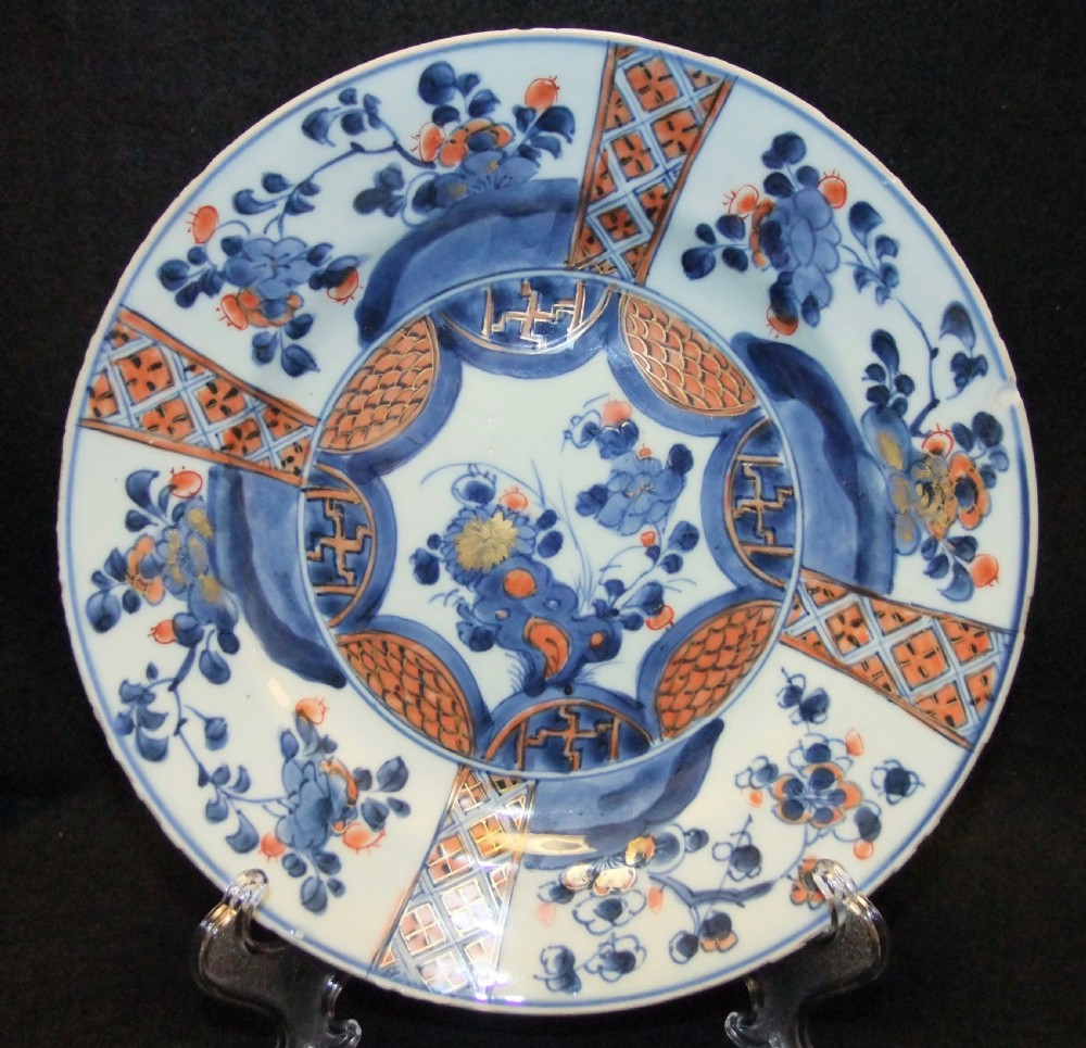 A set of six Chinese Imari porcelain plates featuring cobalt blue, iron red, and gilded floral motifs. View IV