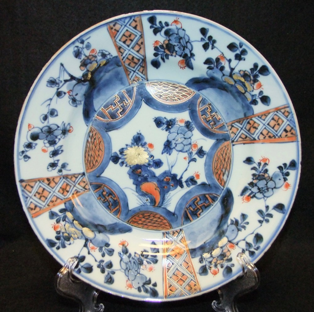 A set of six Chinese Imari porcelain plates featuring cobalt blue, iron red, and gilded floral motifs. View V