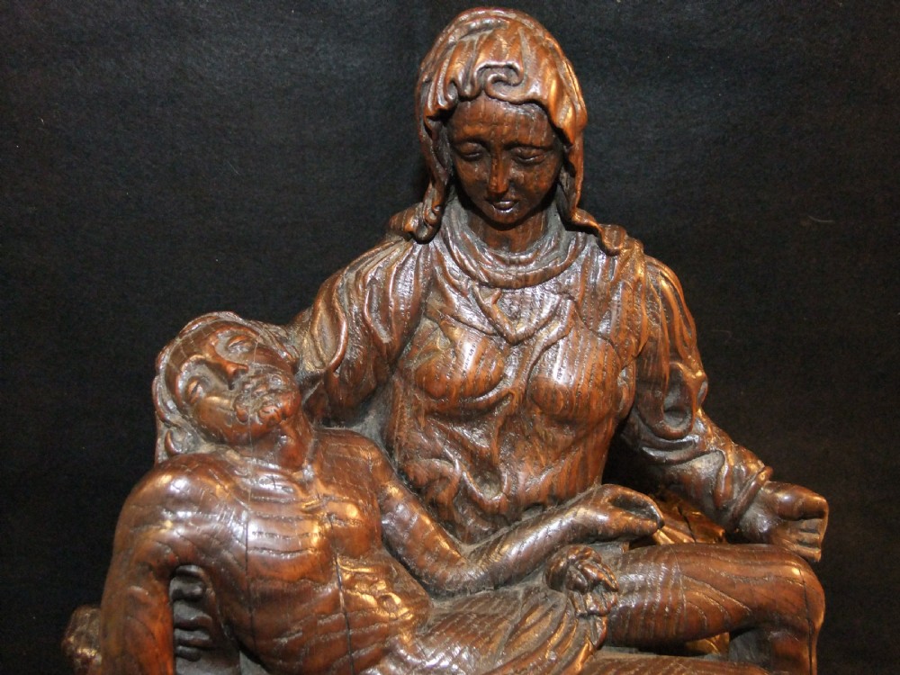 A medieval hand-carved oak sculpture depicting the Virgin Mary cradling the body of Christ. View II