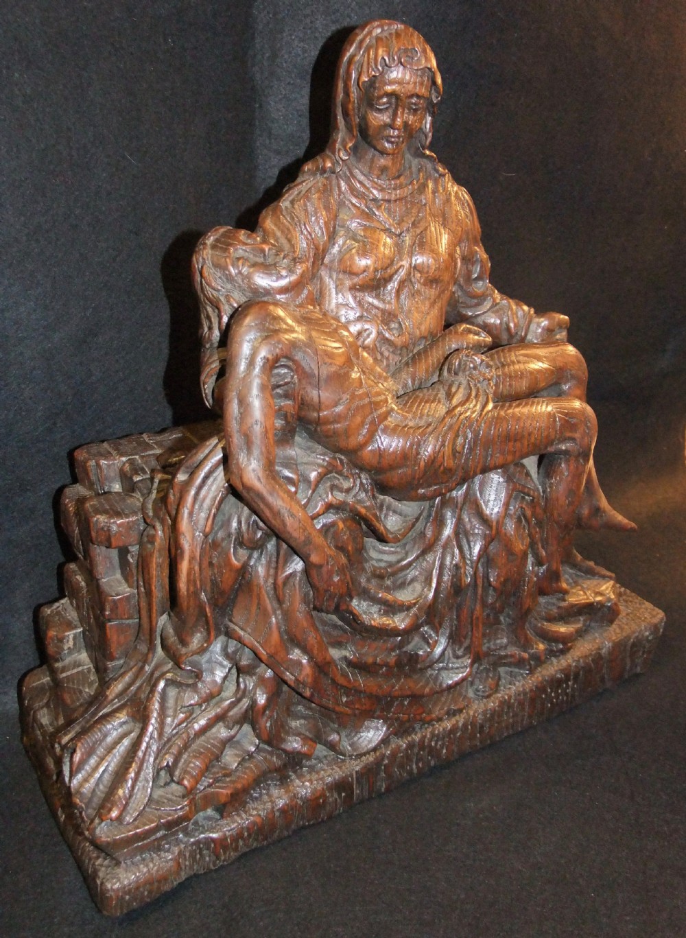 A medieval hand-carved oak sculpture depicting the Virgin Mary cradling the body of Christ. View III