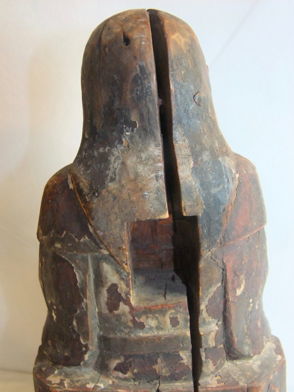 An antique Chinese hand-carved dark wood statue depicting a seated figure in traditional Qing Dynasty robes with traces of gilding and red lacquer. View IX