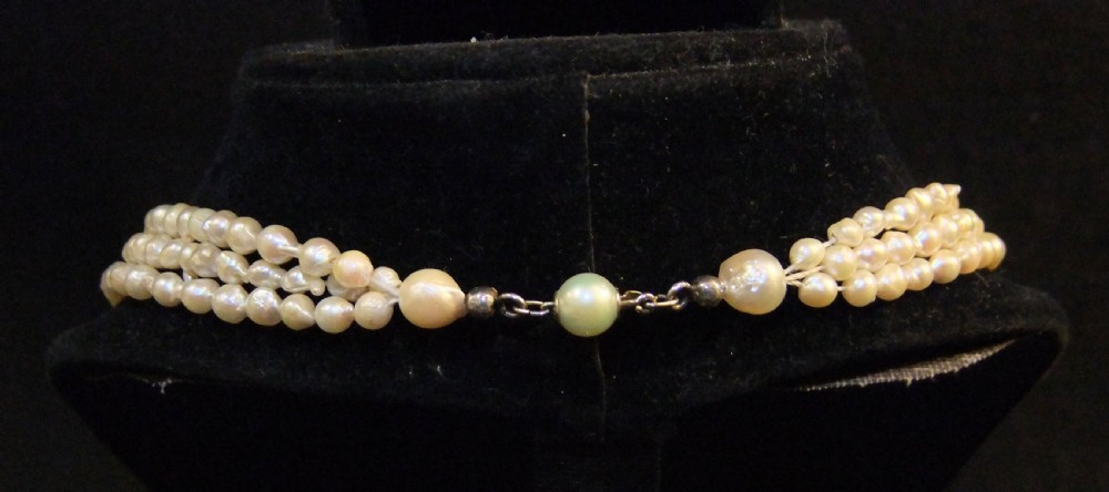 A Victorian three-strand natural pearl necklace featuring cream-coloured pearls woven together. View III