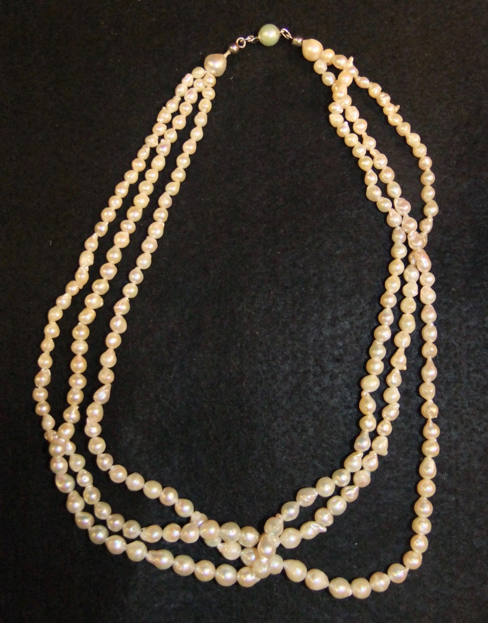 A Victorian three-strand natural pearl necklace featuring cream-coloured pearls woven together. View IV