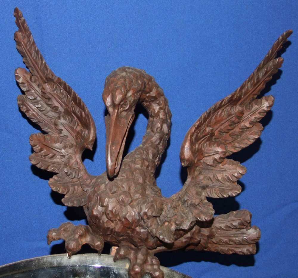 A late 19th-century carved wood mirror featuring a crescent moon-shaped glass surrounded by detailed carvings of wading birds and reeds. View IV