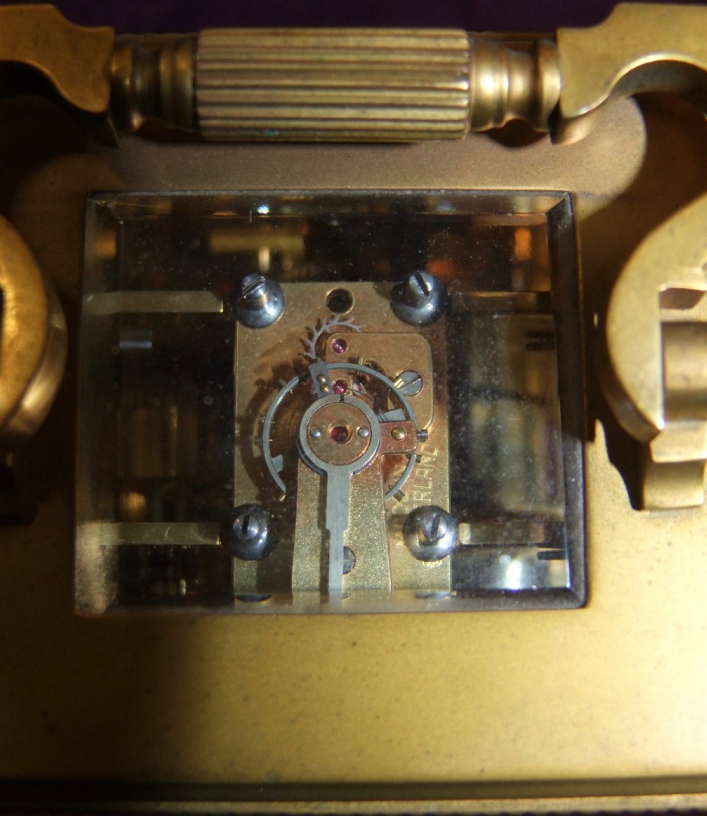A gilt bronze antique carriage clock featuring a rectangular glass case, top carrying handle, Roman numeral dial, alarm sub-dial, and accompanying winding key. View VIII