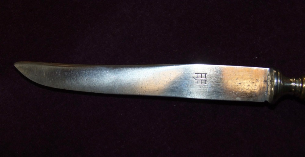 A 19th-century Japanese knife featuring a single-edged steel blade and a relief-carved bronze handle depicting a monkey reaching for the moon. View III