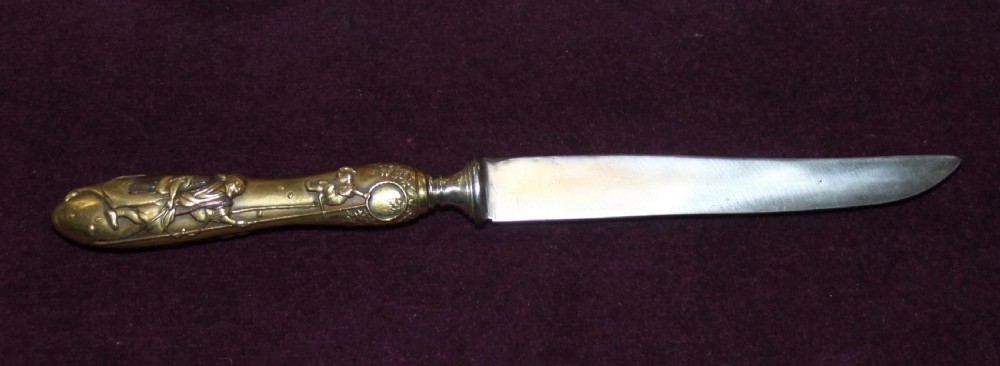 A 19th-century Japanese knife featuring a single-edged steel blade and a relief-carved bronze handle depicting a monkey reaching for the moon. View IV