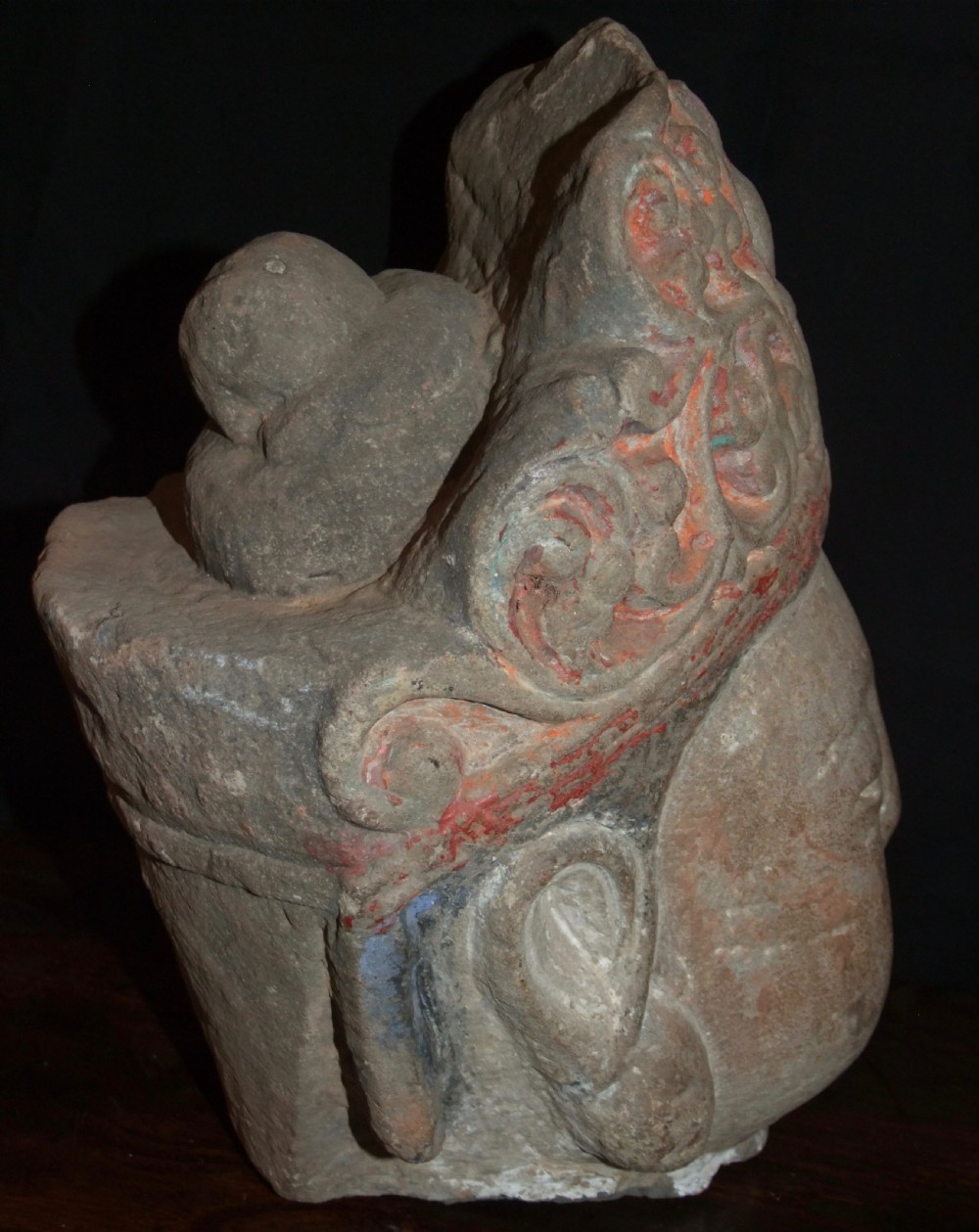 Carved sandstone head of Avalokiteshvara featuring an elaborate crown, gentle facial contours, and visible traces of red and green pigment. View V