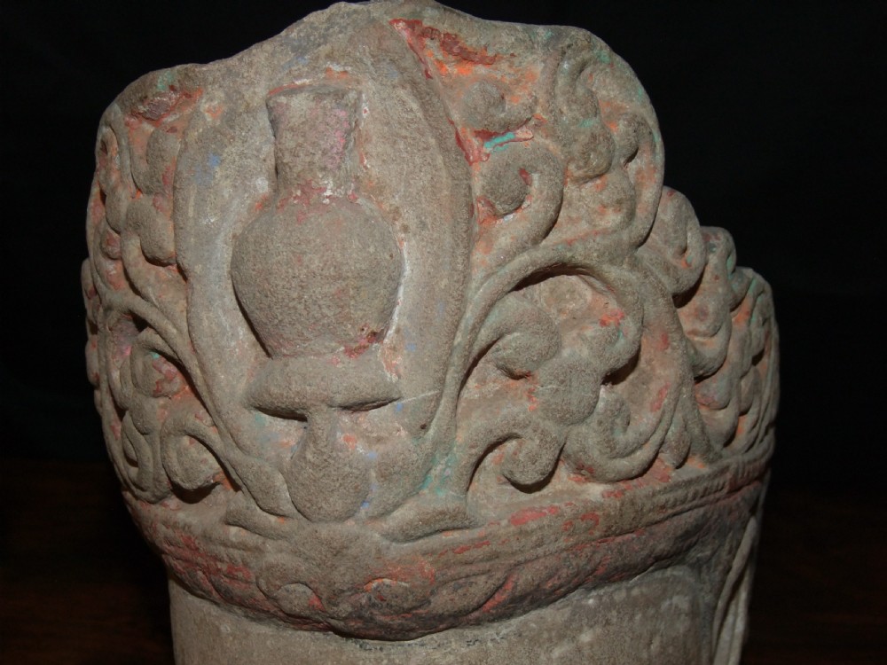 Carved sandstone head of Avalokiteshvara featuring an elaborate crown, gentle facial contours, and visible traces of red and green pigment. View VI